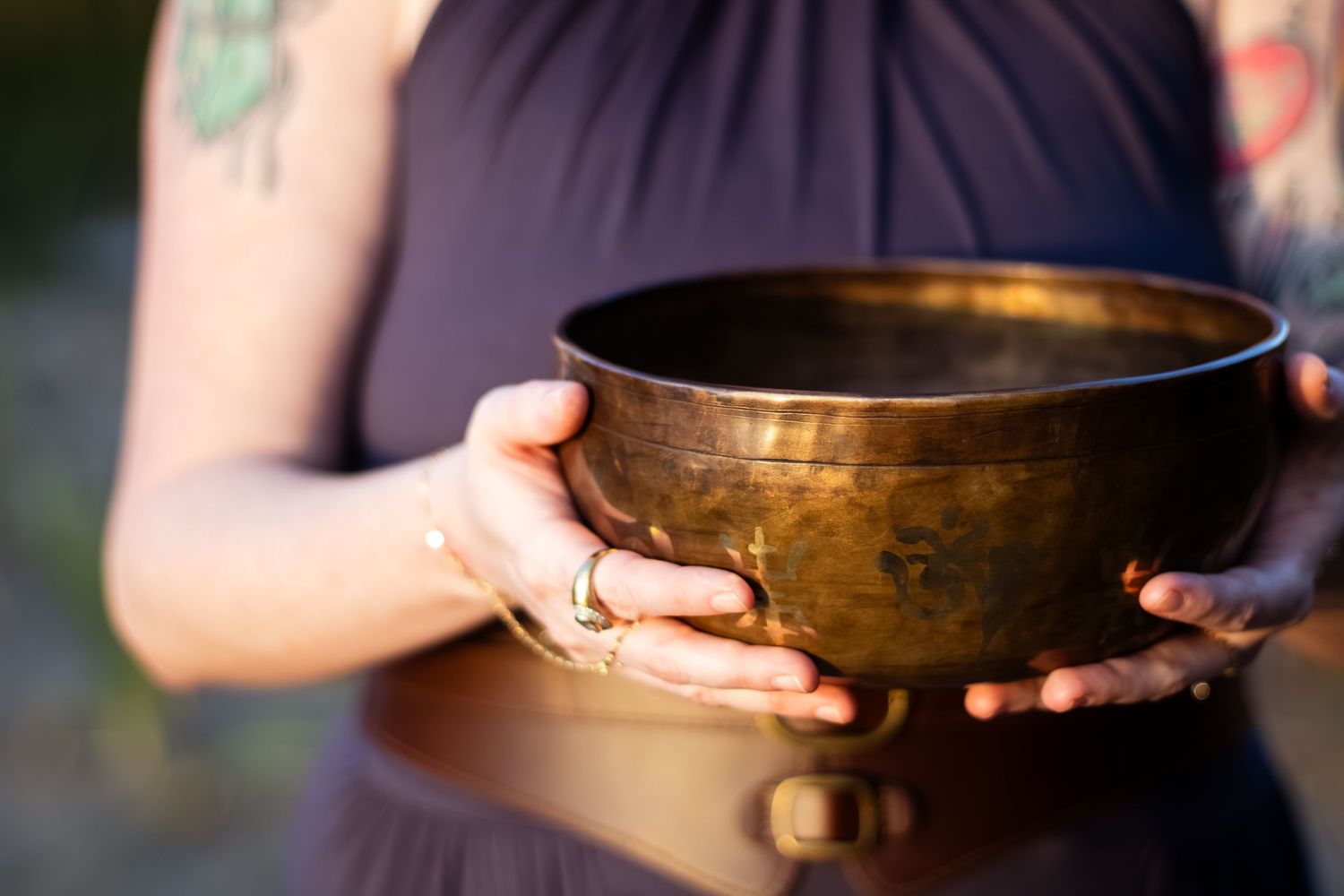 A person holds a Tibetan singing bowl in various positions showing its use in meditation and sound healing practice.
