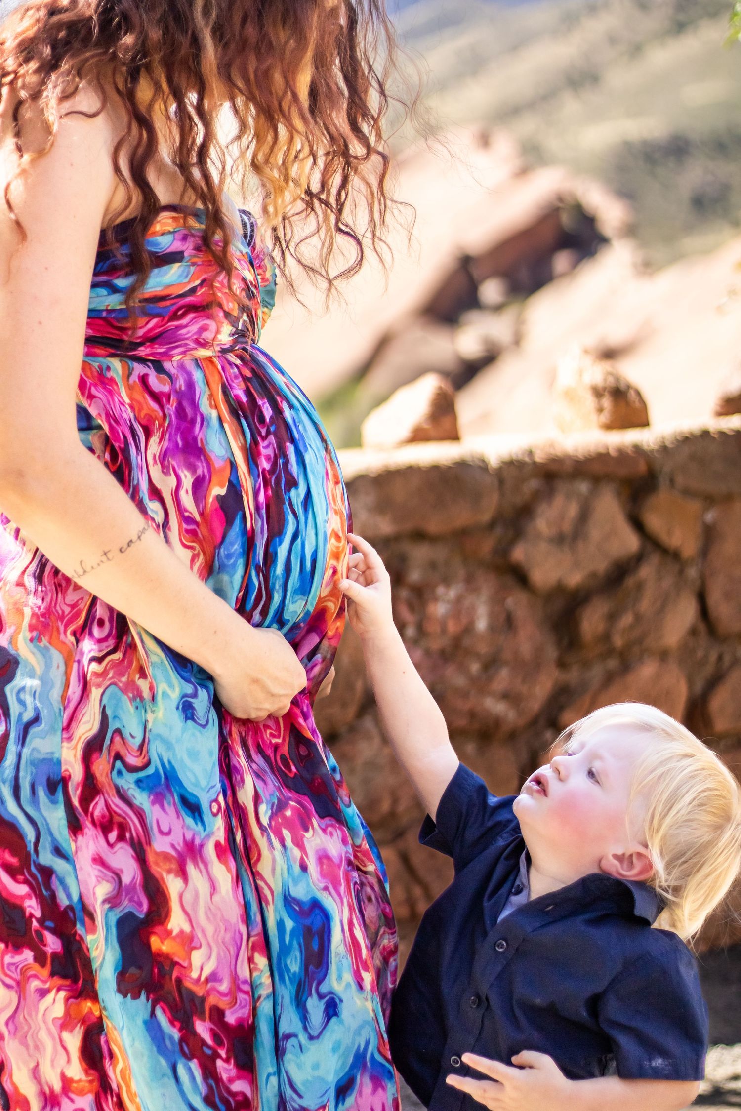 A colorful swirling dress flows as a child reaches up playfully in a series of candid outdoor moments.