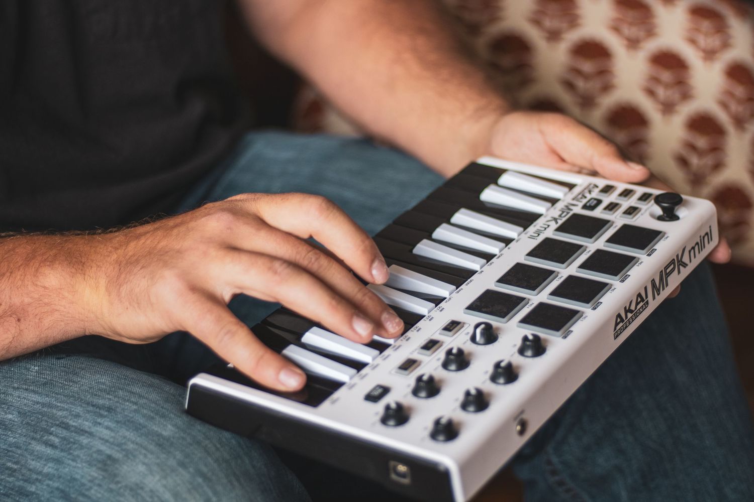 A sequence of close-up shots showing hands adjusting knobs and controls on a MIDI controller keyboard.