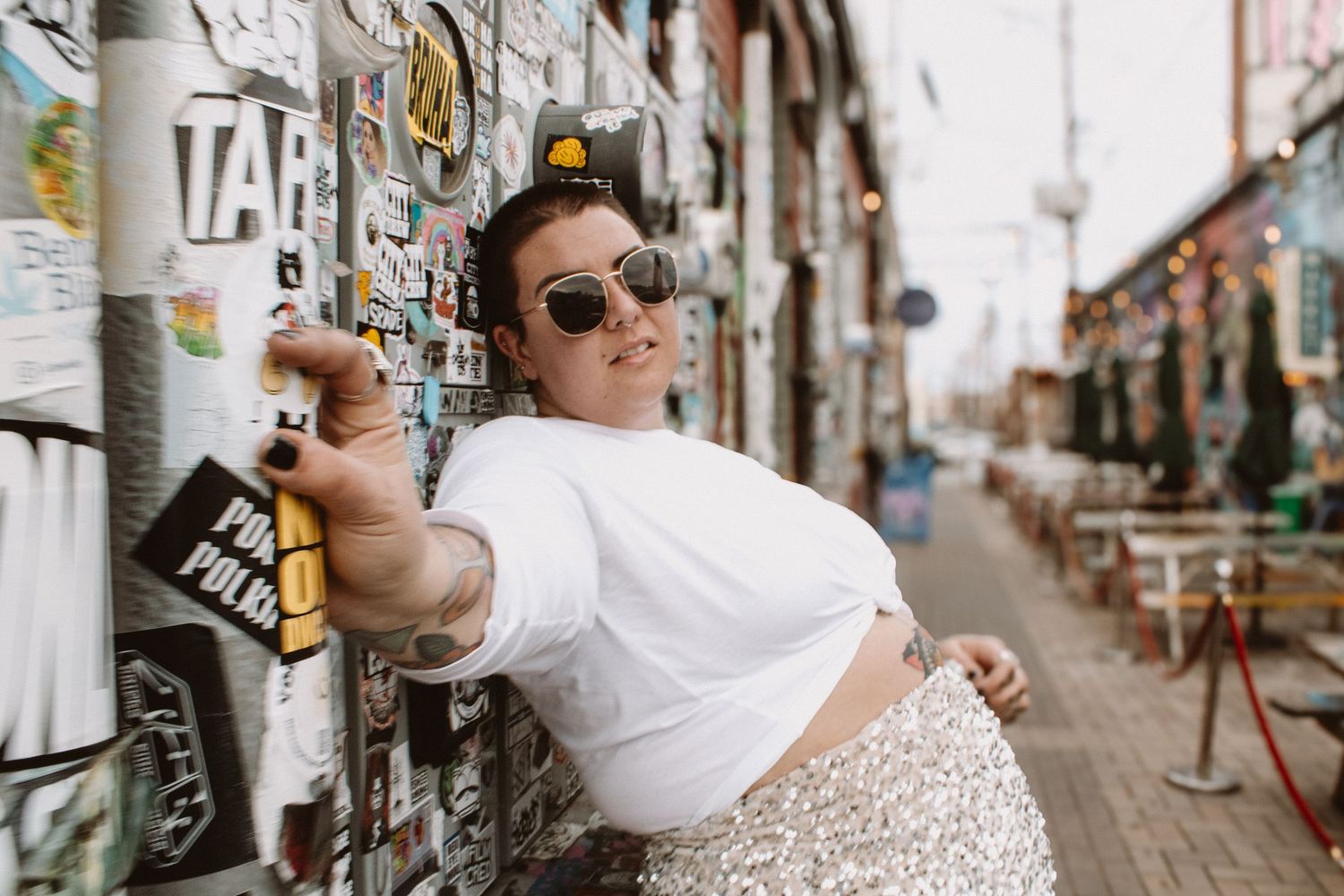 A collection of candid wedding photos showing intimate moments between newlyweds in an urban setting with graffiti walls.