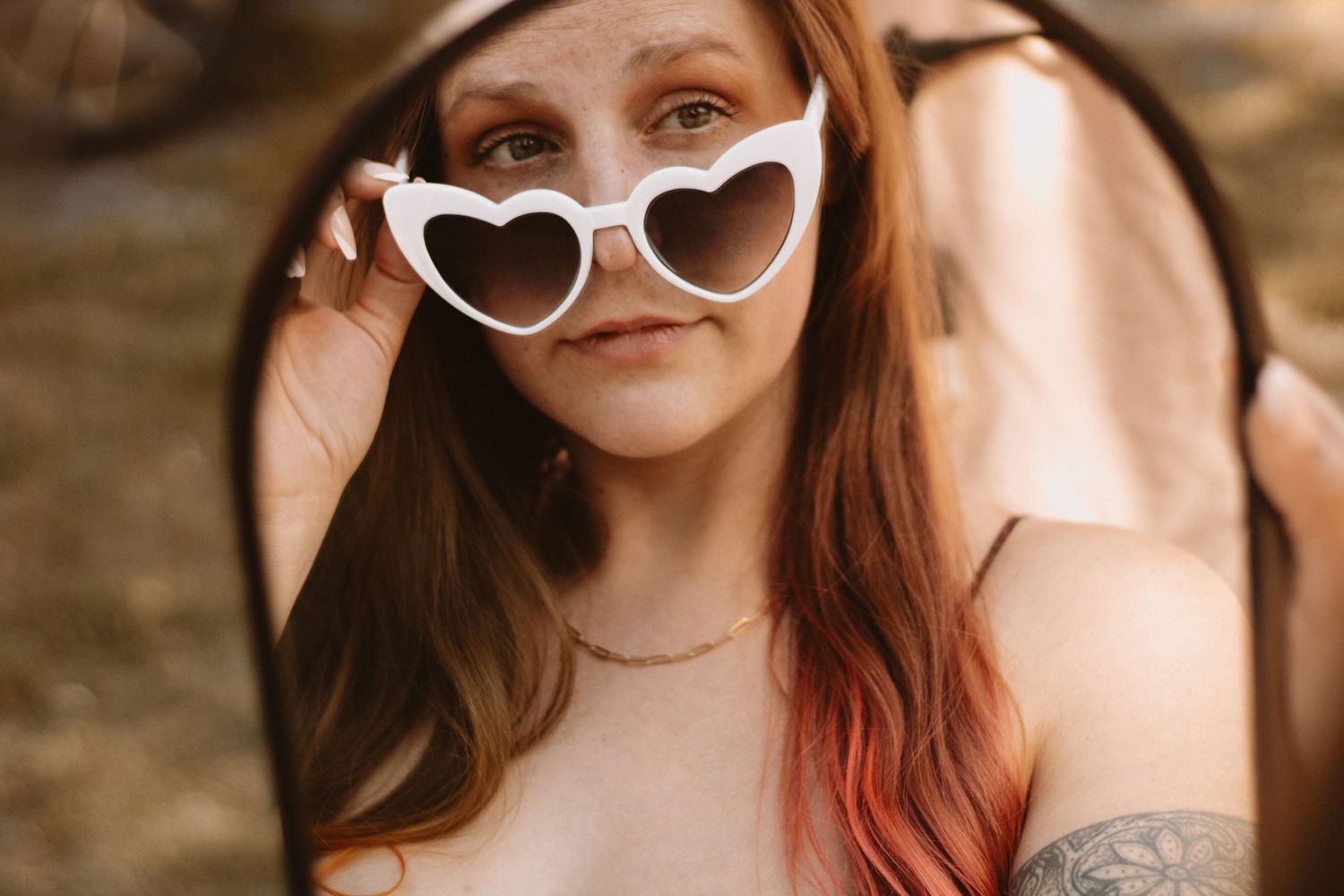 Close-up portrait shots of a person wearing white cat-eye sunglasses with pink accents.