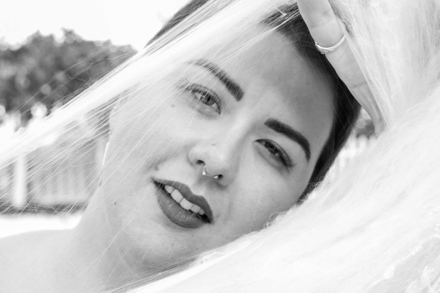 A black and white photo collage showing a person smiling and posing in different angles.