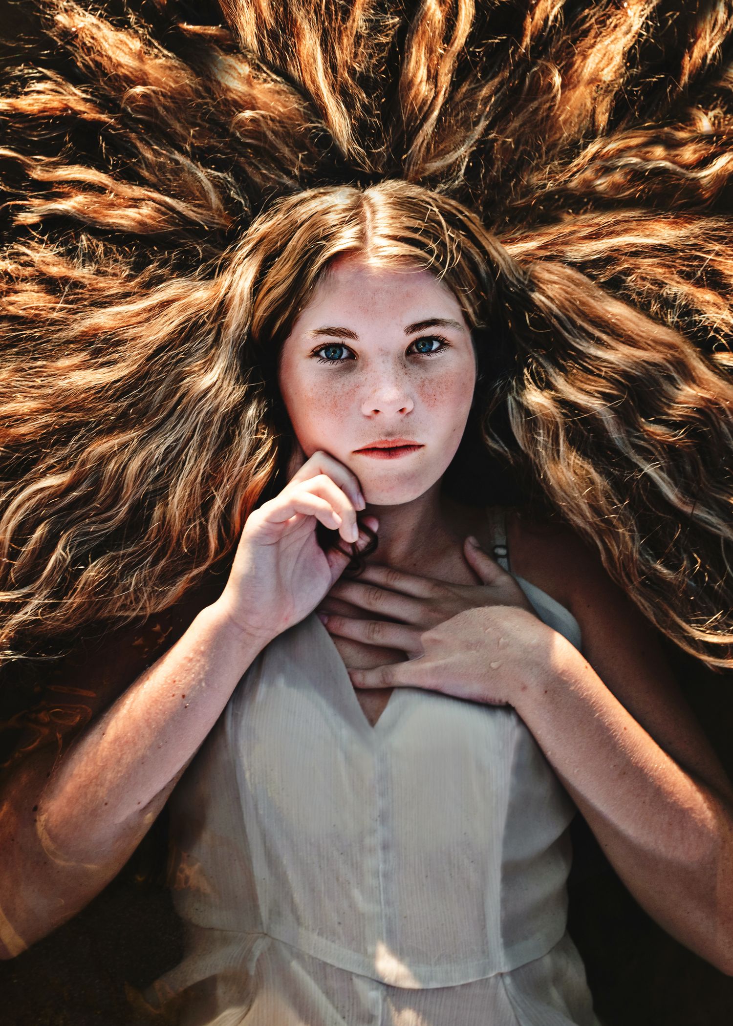 Artistic sequence showing hair flowing dynamically in warm dramatic lighting against a dark background.