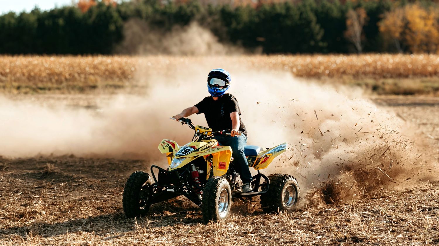 Action sequence of ATVs kicking up dust while riding through desert terrain.