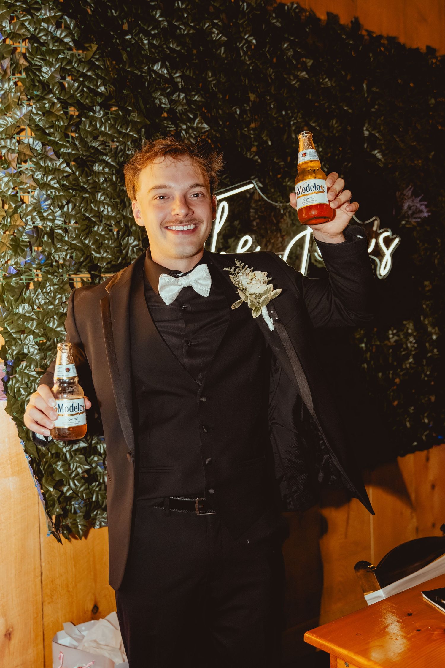 A series of playful photos showing someone in formal attire posing with a beer bottle in different positions.