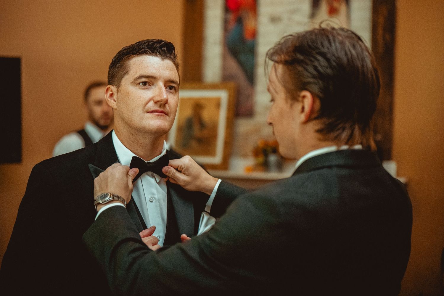 Wedding guests react with joy and laughter during an emotional reception moment.