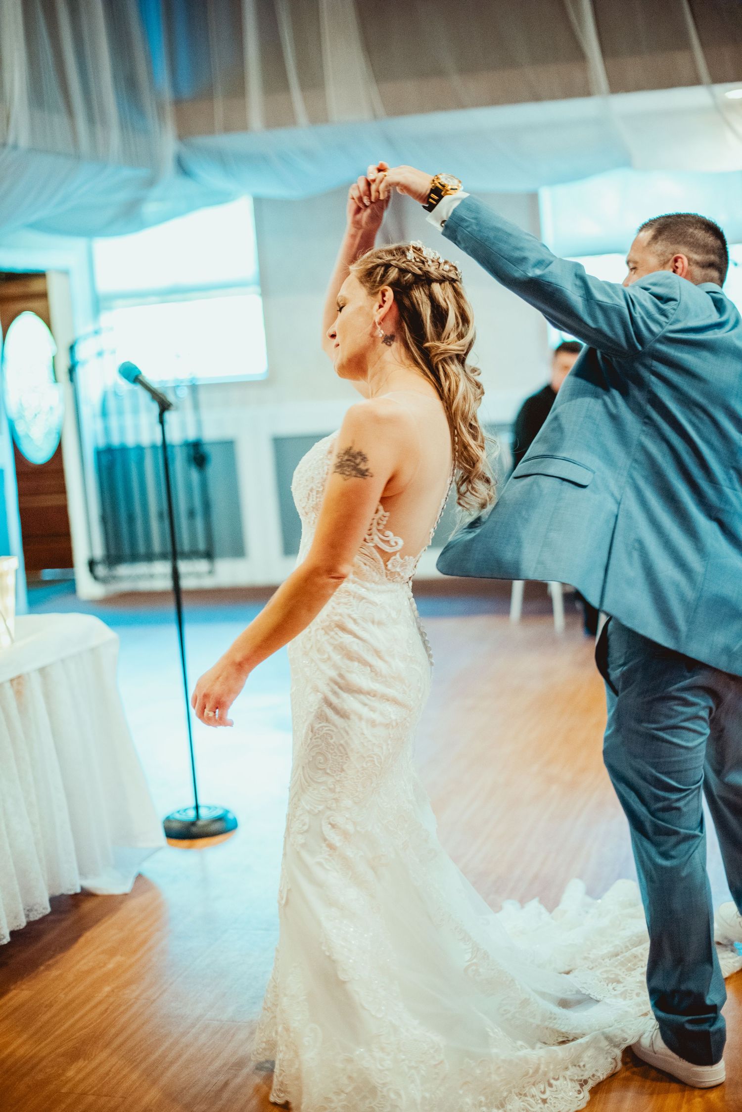 Sequence of four photos showing a couple performing a fun dip dance move during their first dance at a wedding reception.