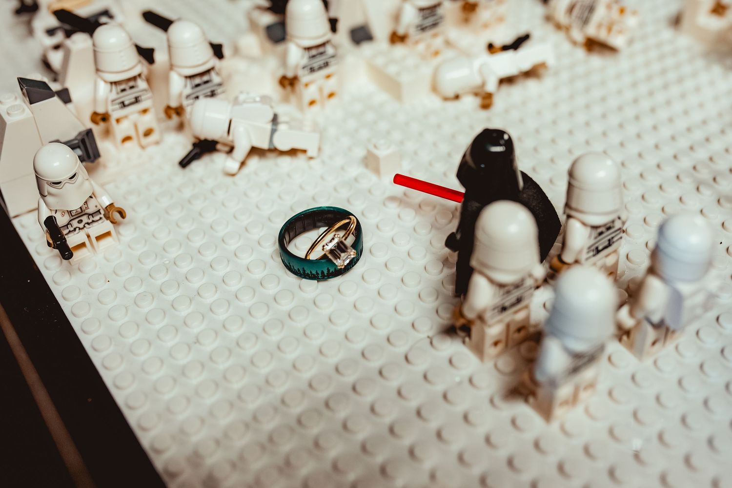A time-lapse sequence showing LEGO bricks being assembled into a structure on a white baseplate.