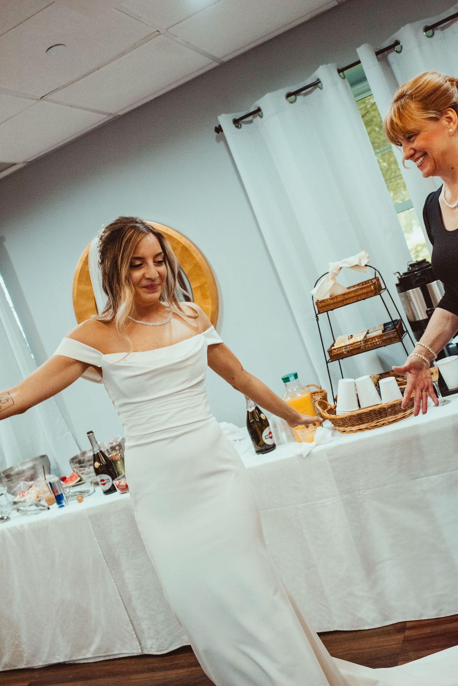 Person in white wedding dress preparing at a dressing table.
