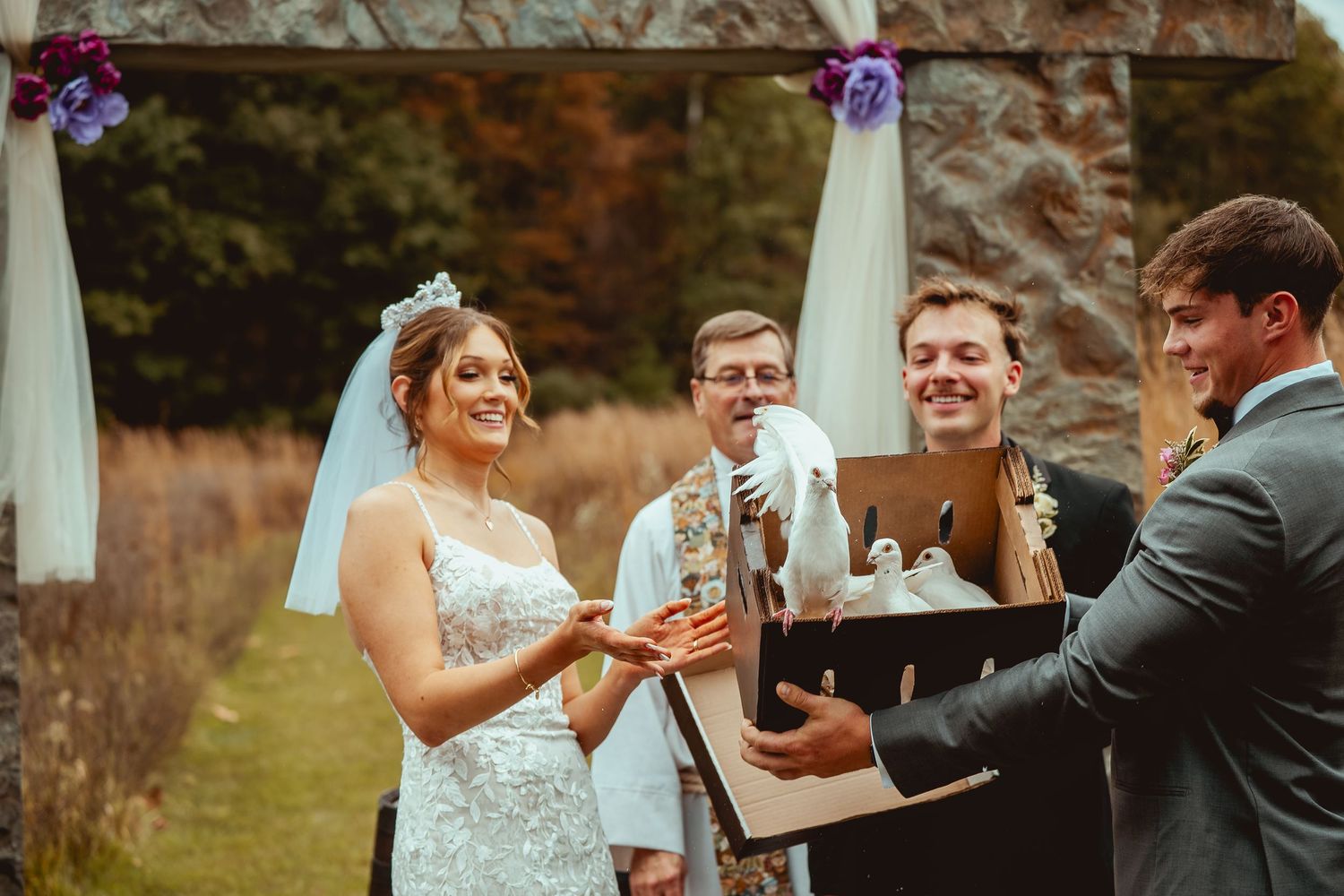 Wedding party celebrates with champagne toasts and laughter in an outdoor garden setting.