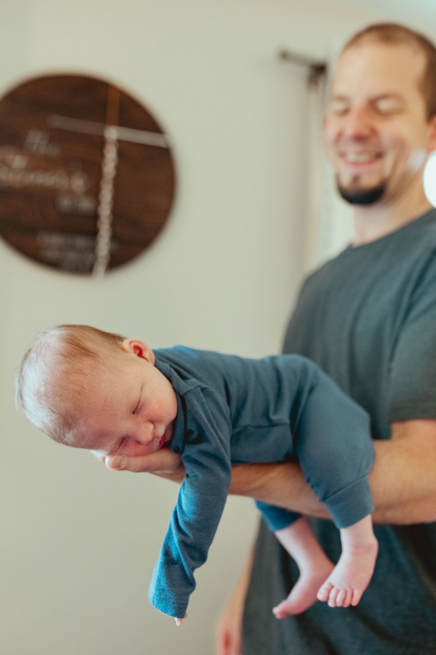 A sequence of photos showing a baby being playfully swung upside down by an adult in a blue shirt.