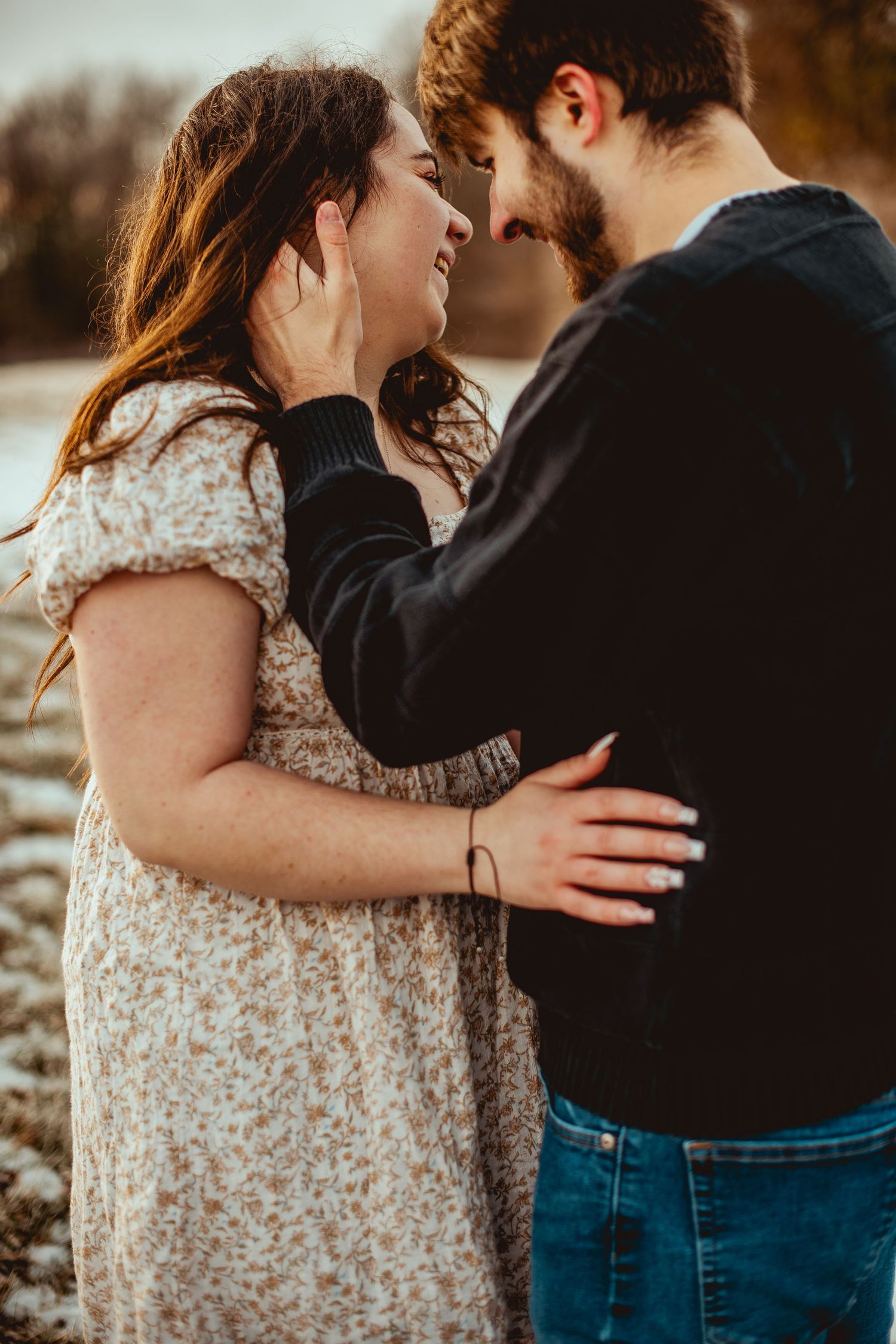 A tender romantic moment captured between a couple in warm sunset lighting.
