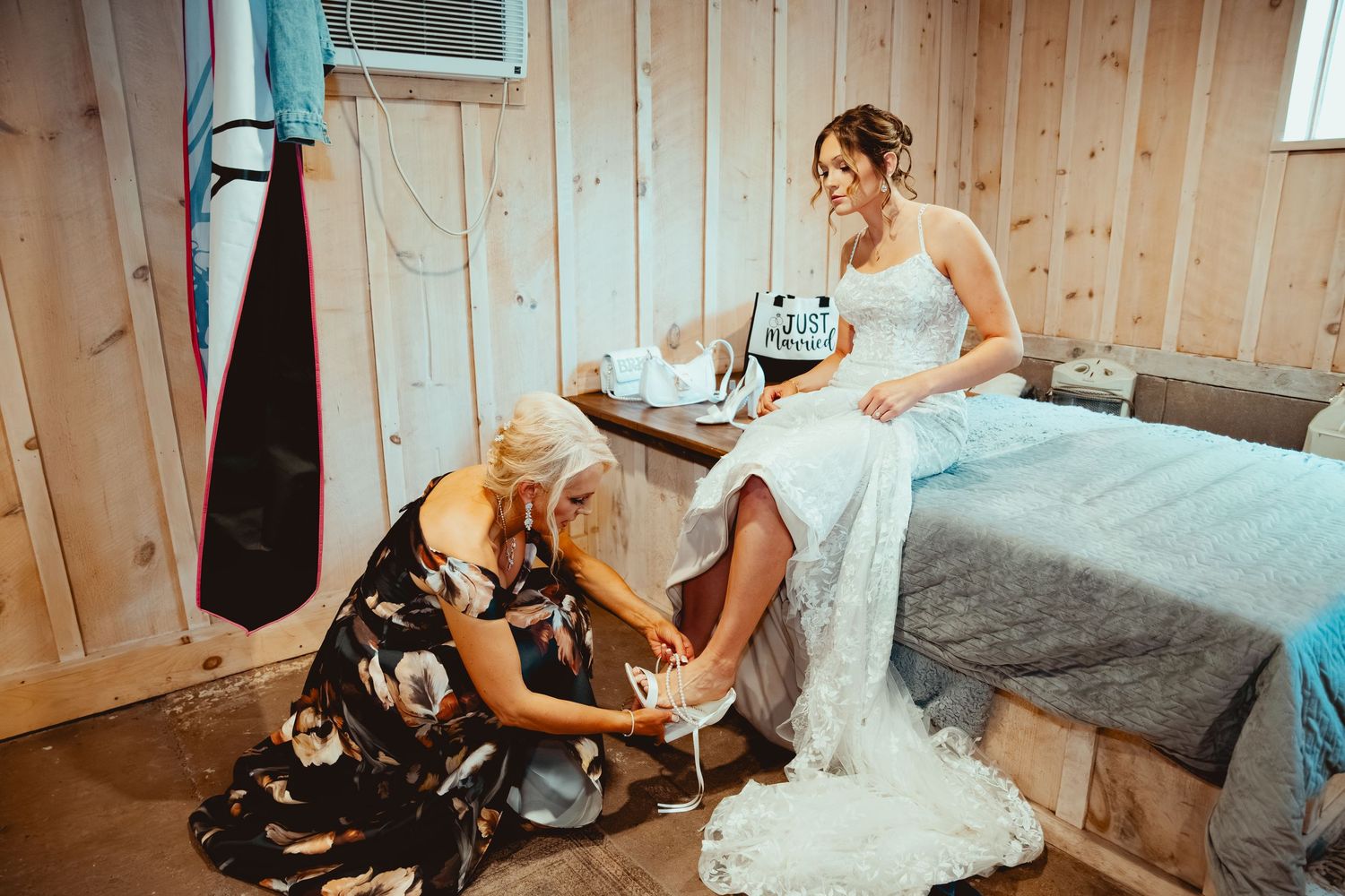 Wedding party getting ready in cozy rustic cabin interior with wood paneled walls.