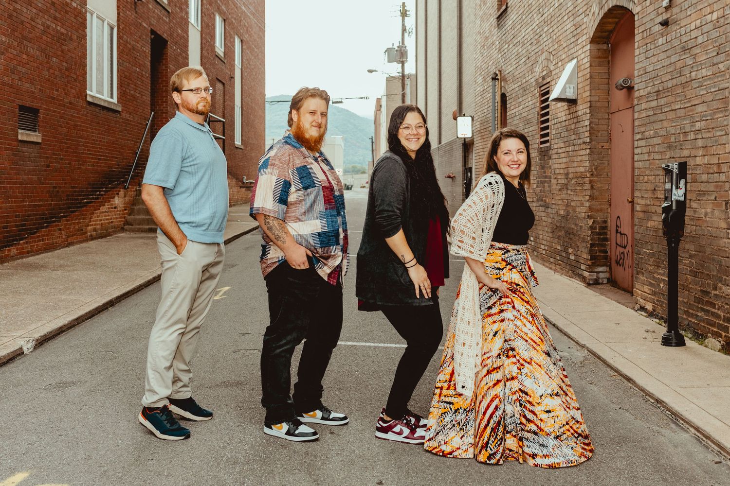 Fun group portraits taken in an urban alleyway between historic buildings.