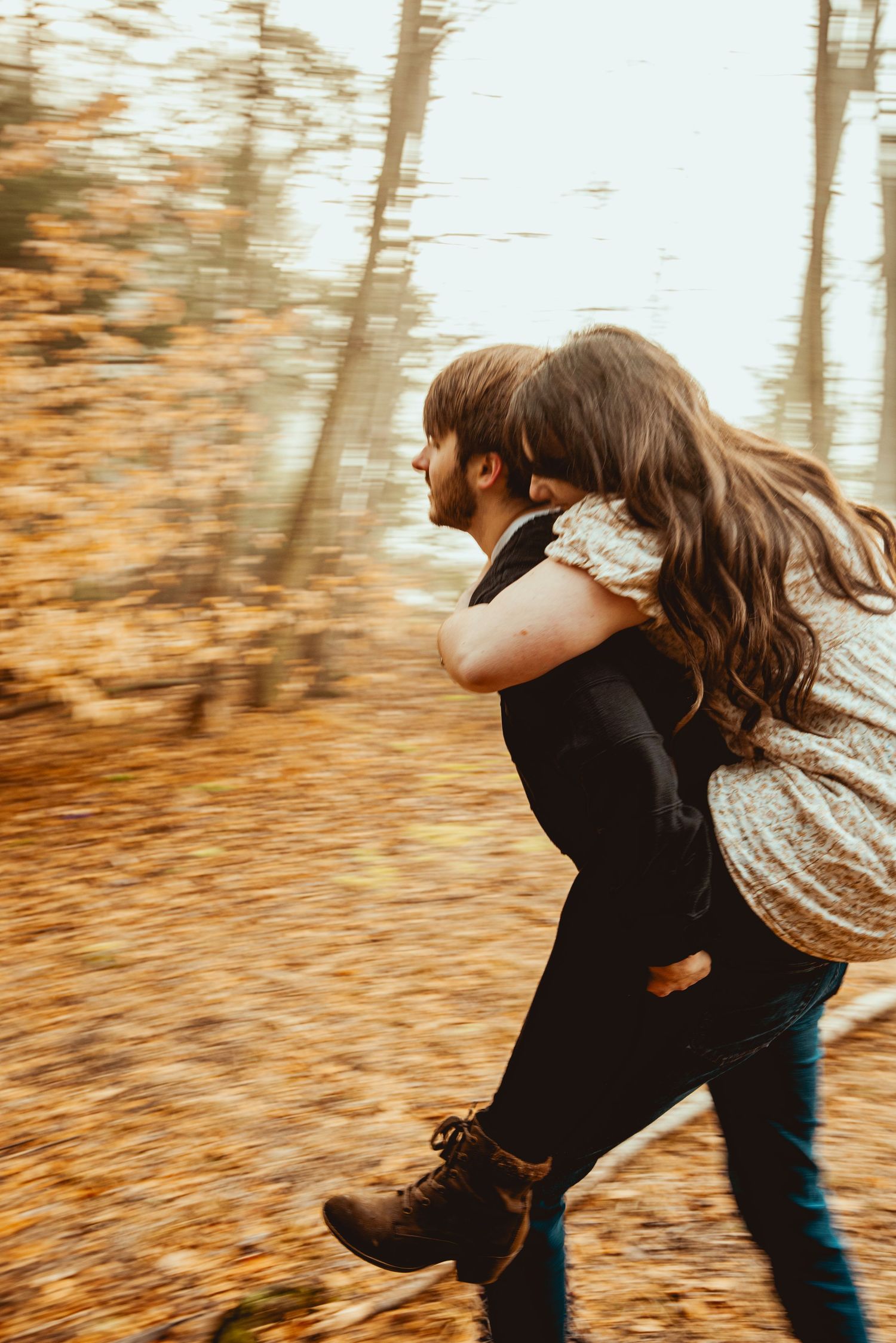 A romantic piggyback ride through a golden autumn forest with motion blur.