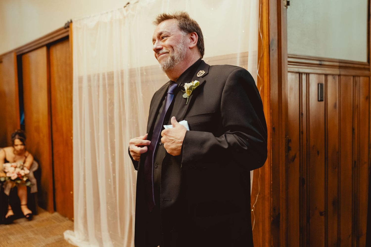 Wedding party members in formal attire stand together in a church sanctuary.