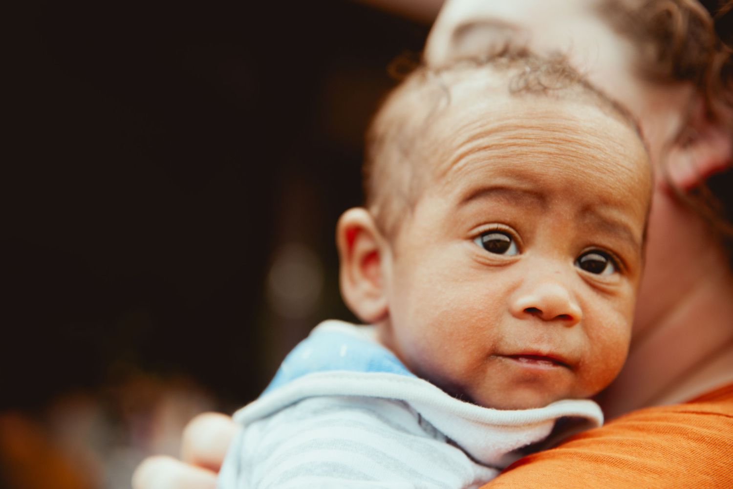 A series of seven close-up photos showing a baby's various facial expressions and reactions.