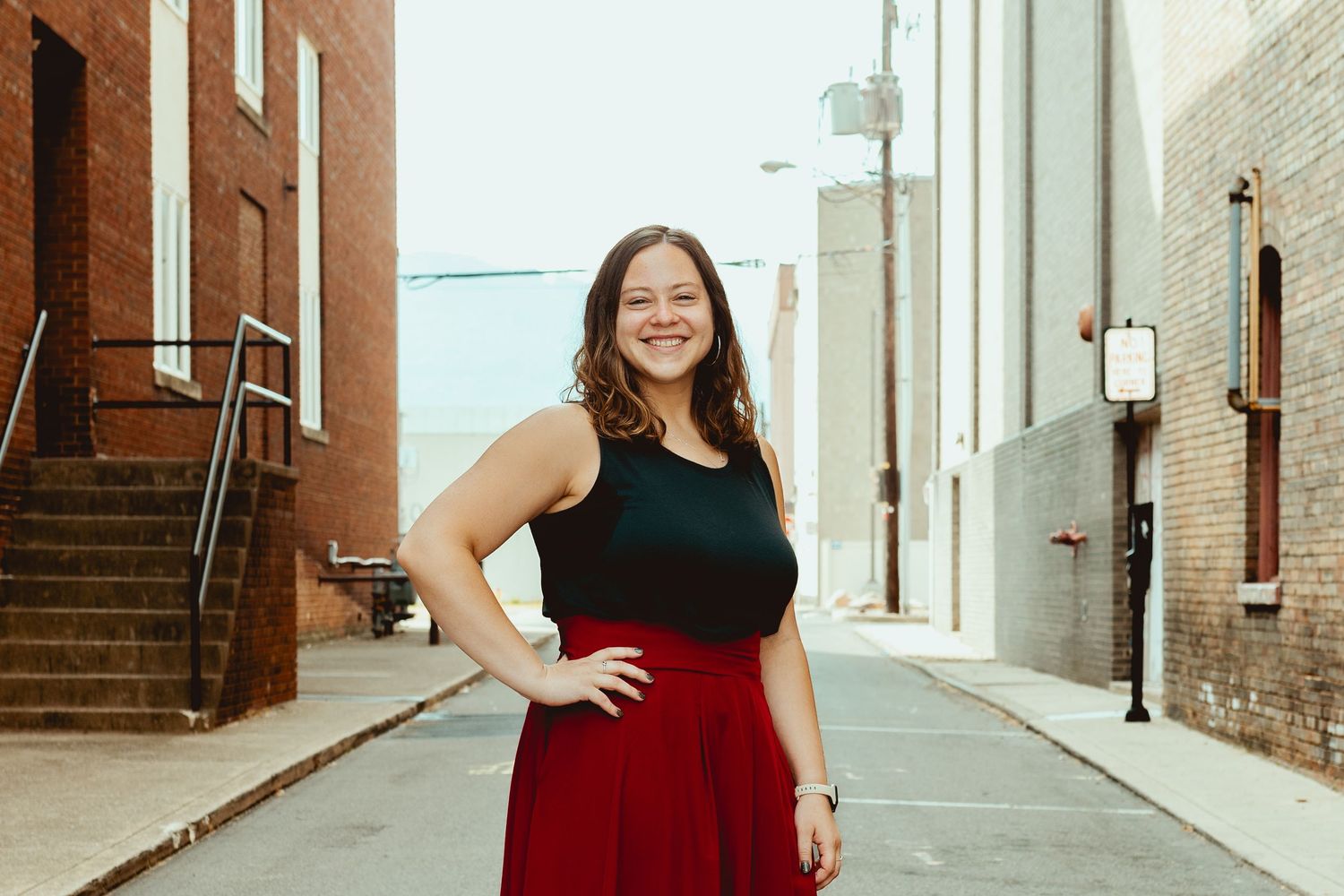 A series of five connected photos showing someone in red and black outfits posing in an urban corridor.