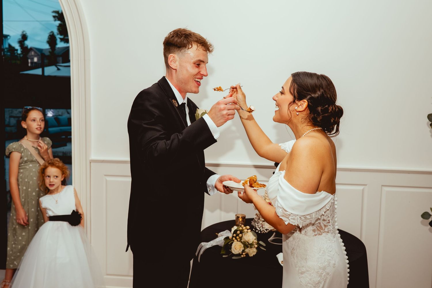 A collection of candid wedding reception moments showing dancing and celebration in an elegant white room.