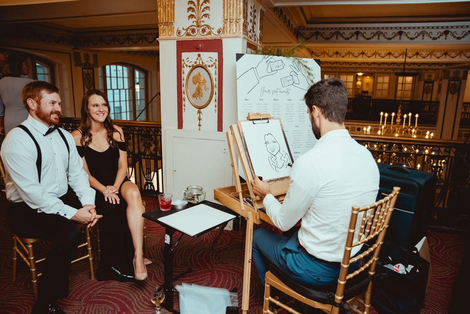 Wedding reception guests enjoying dinner and conversation at elegantly decorated tables.