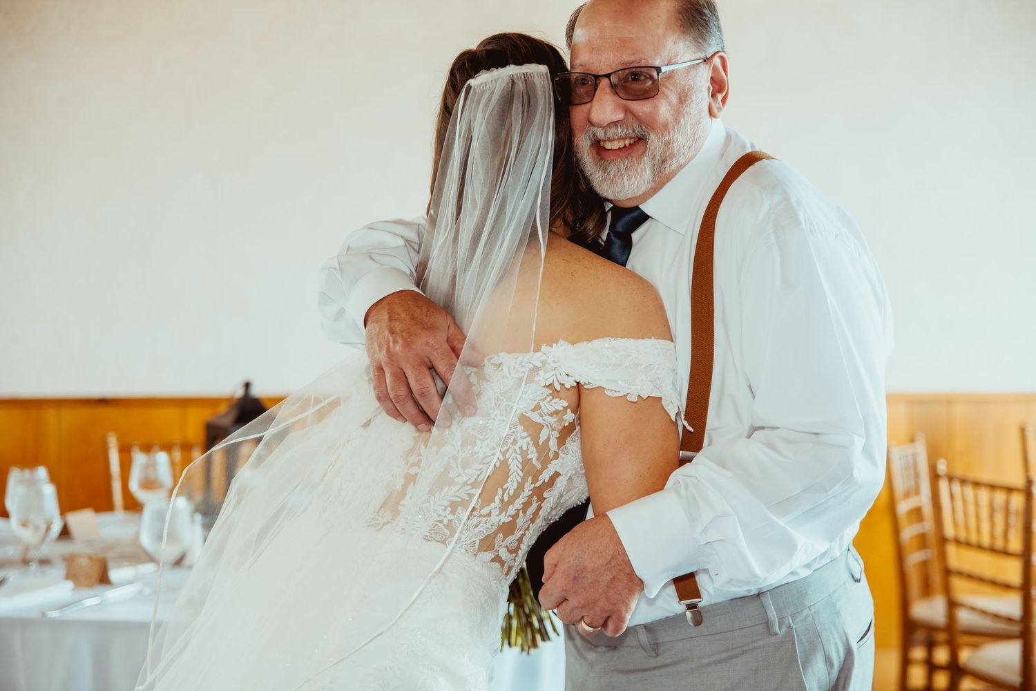 Candid moments of joy and laughter captured during an indoor wedding celebration with warm lighting.