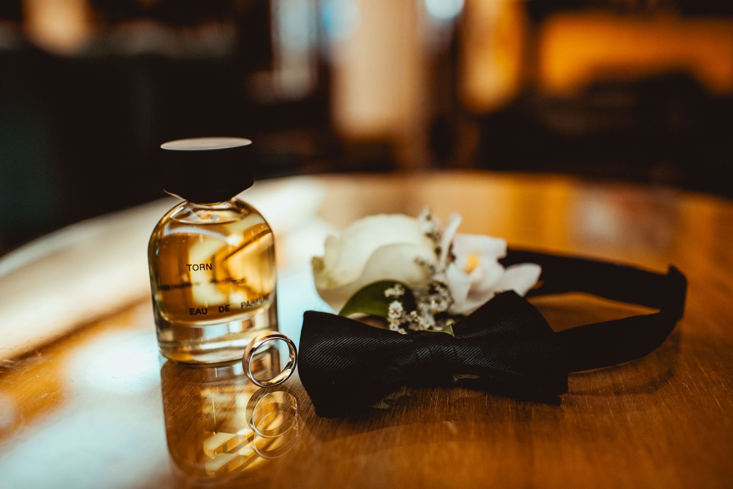 Vintage glass jars and decorative items arranged on a rustic wooden surface in warm lighting.