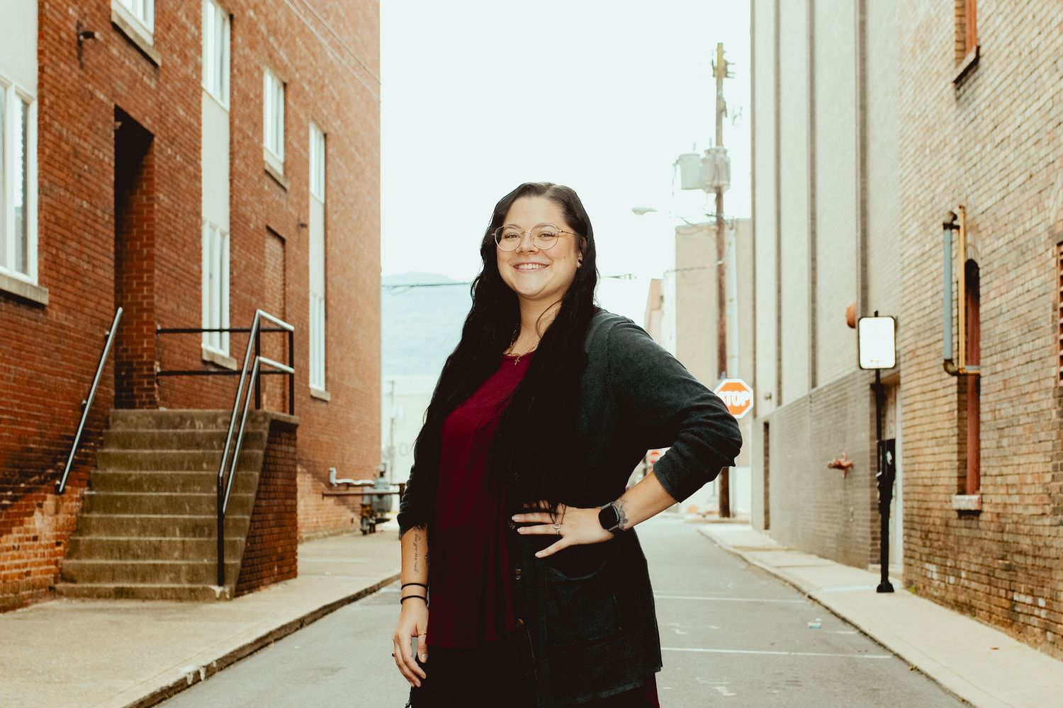 Casual portraits taken in a narrow brick alley with vintage lamp posts.