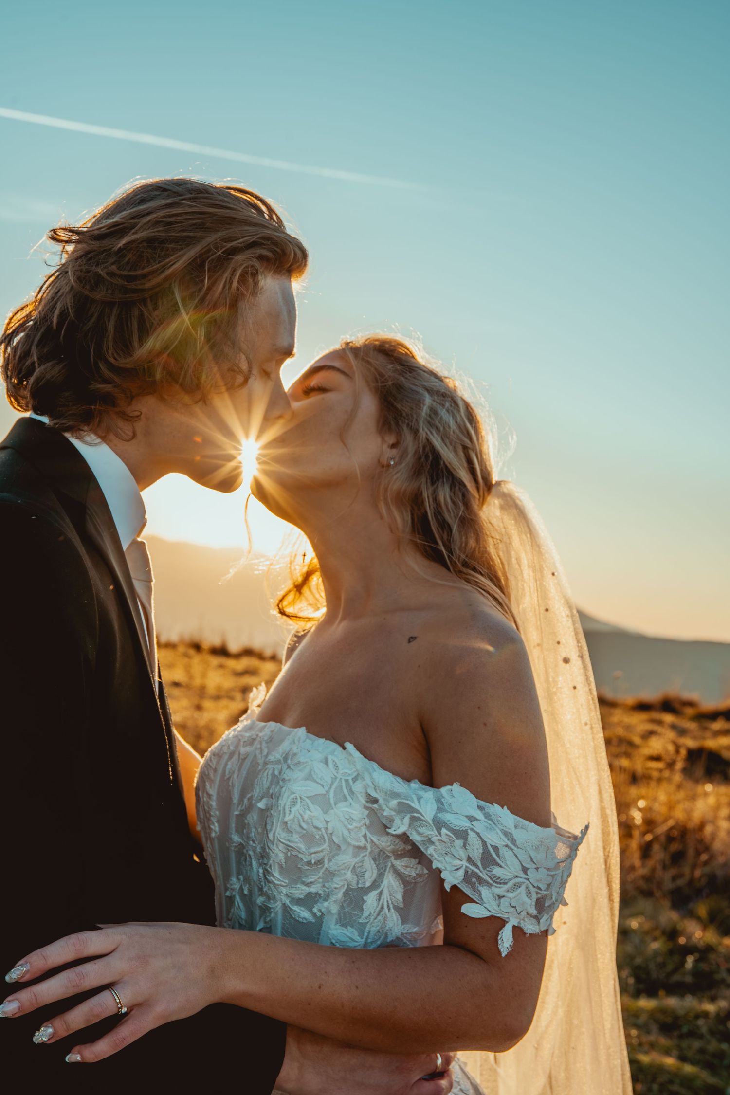 A romantic sunset wedding photo series shows a couple embracing in golden light against a desert landscape.