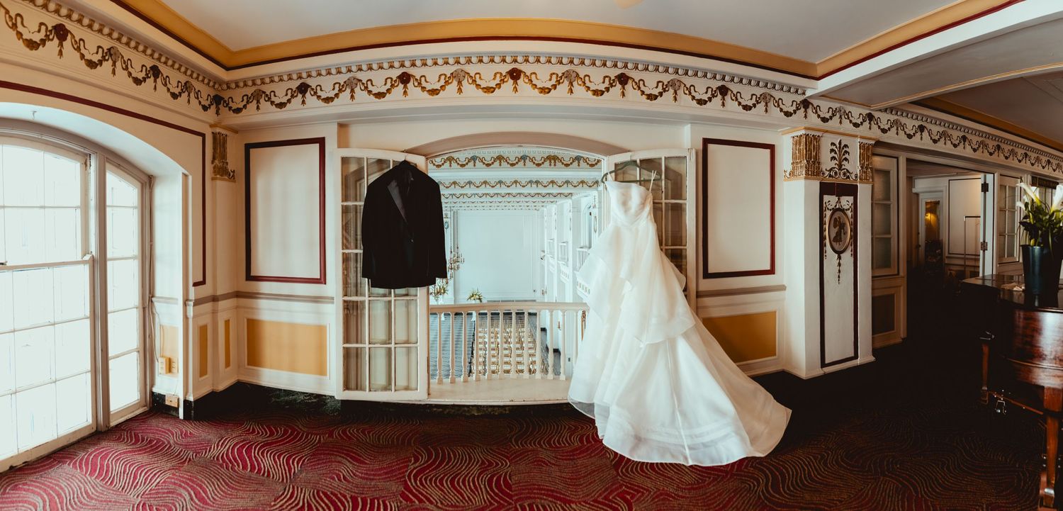 Elegant ballroom interior with ornate gold trim molding and crystal chandeliers.