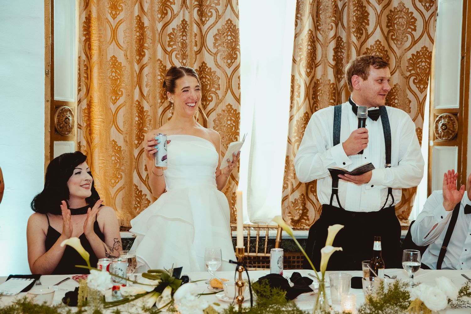 Wedding reception dinner table with formal place settings and elegant decor.