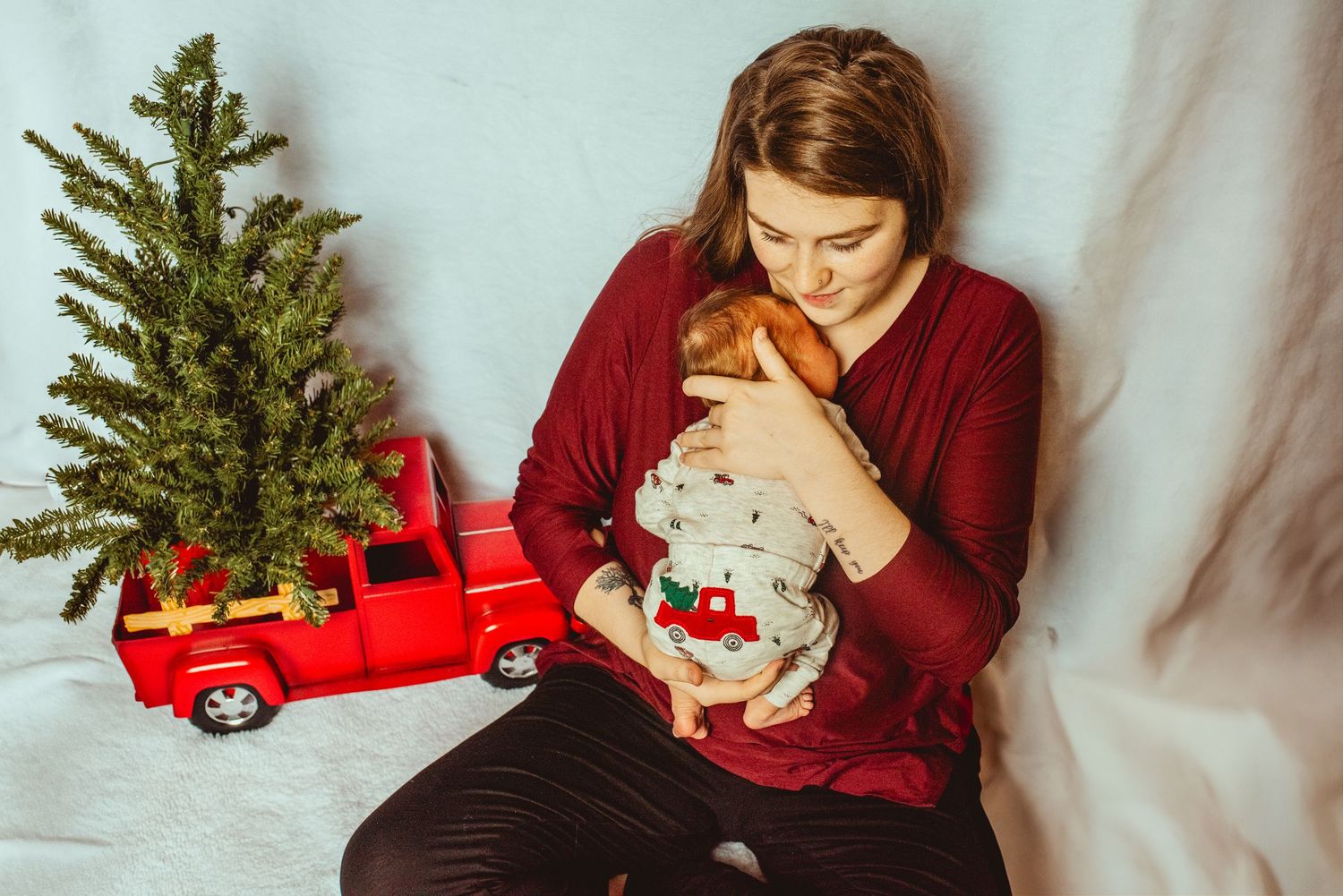A collage of holiday photos with a small Christmas tree, red toy car, and someone in a burgundy sweater.