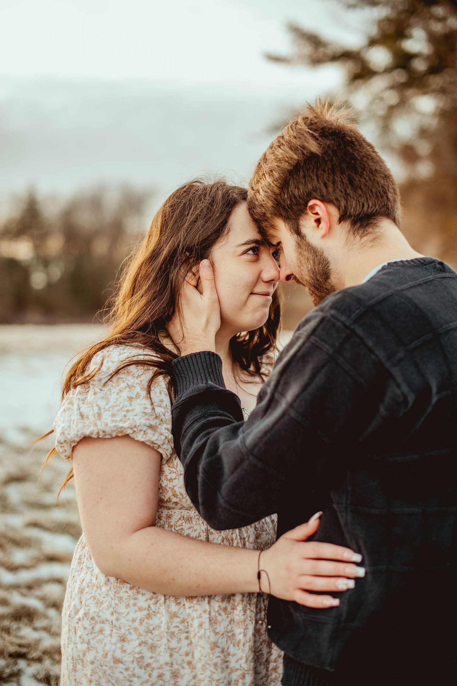 An intimate moment shared between a couple during golden hour by the water.