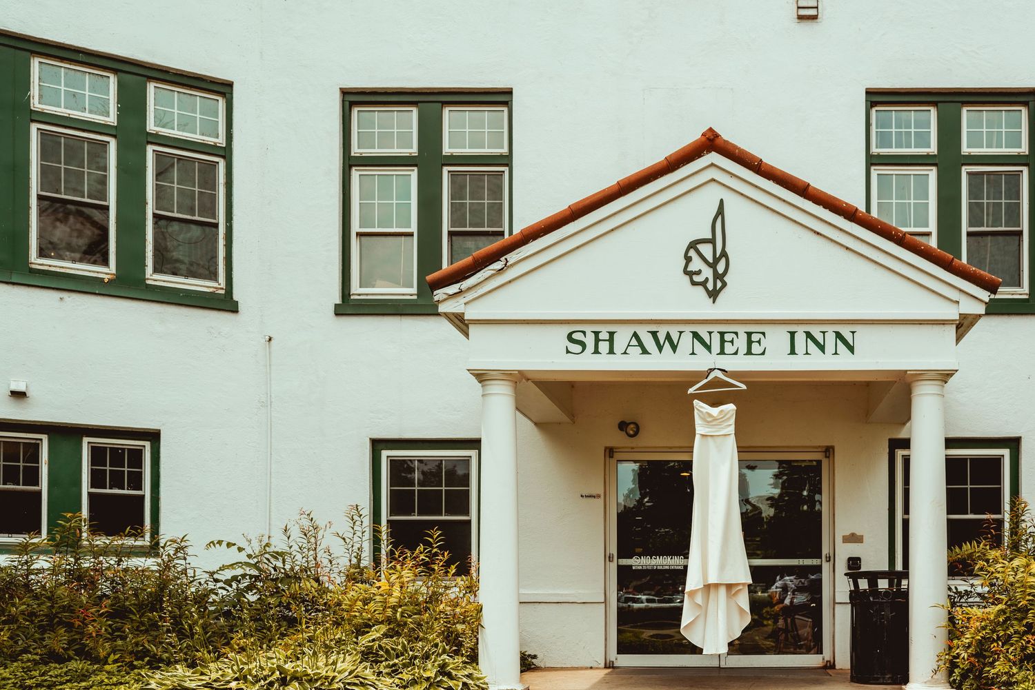 Exterior view of the historic white Shawnee Inn building with multiple windows and colonial architecture details.