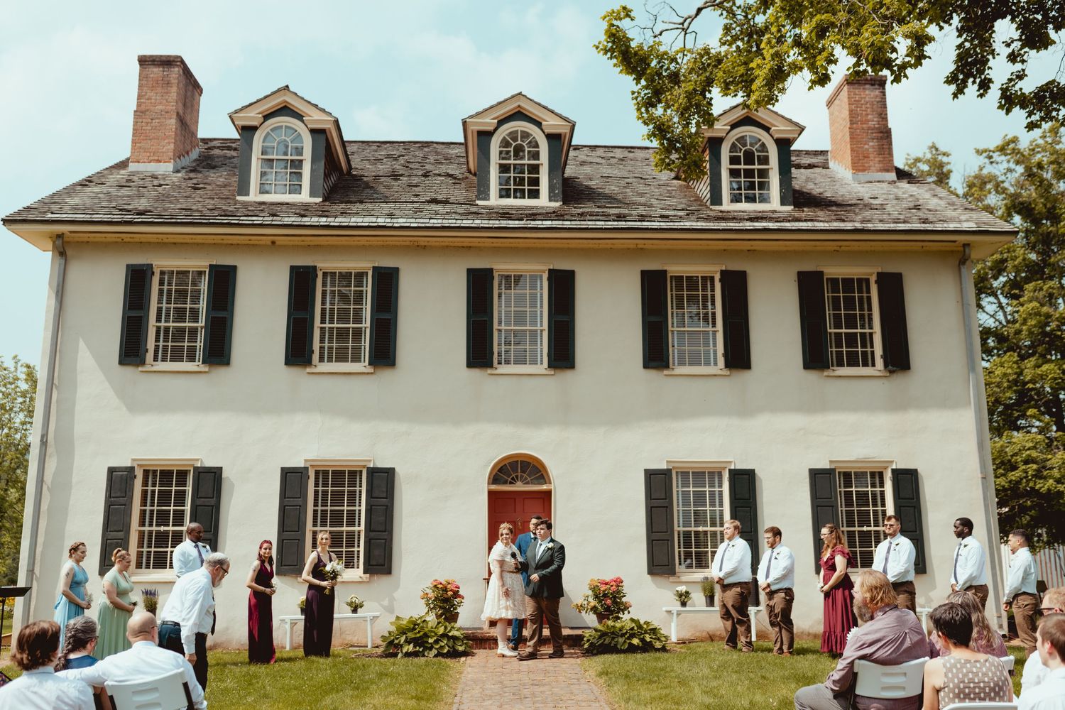 White colonial style mansion with dormer windows and columns photographed from different angles during an outdoor event.
