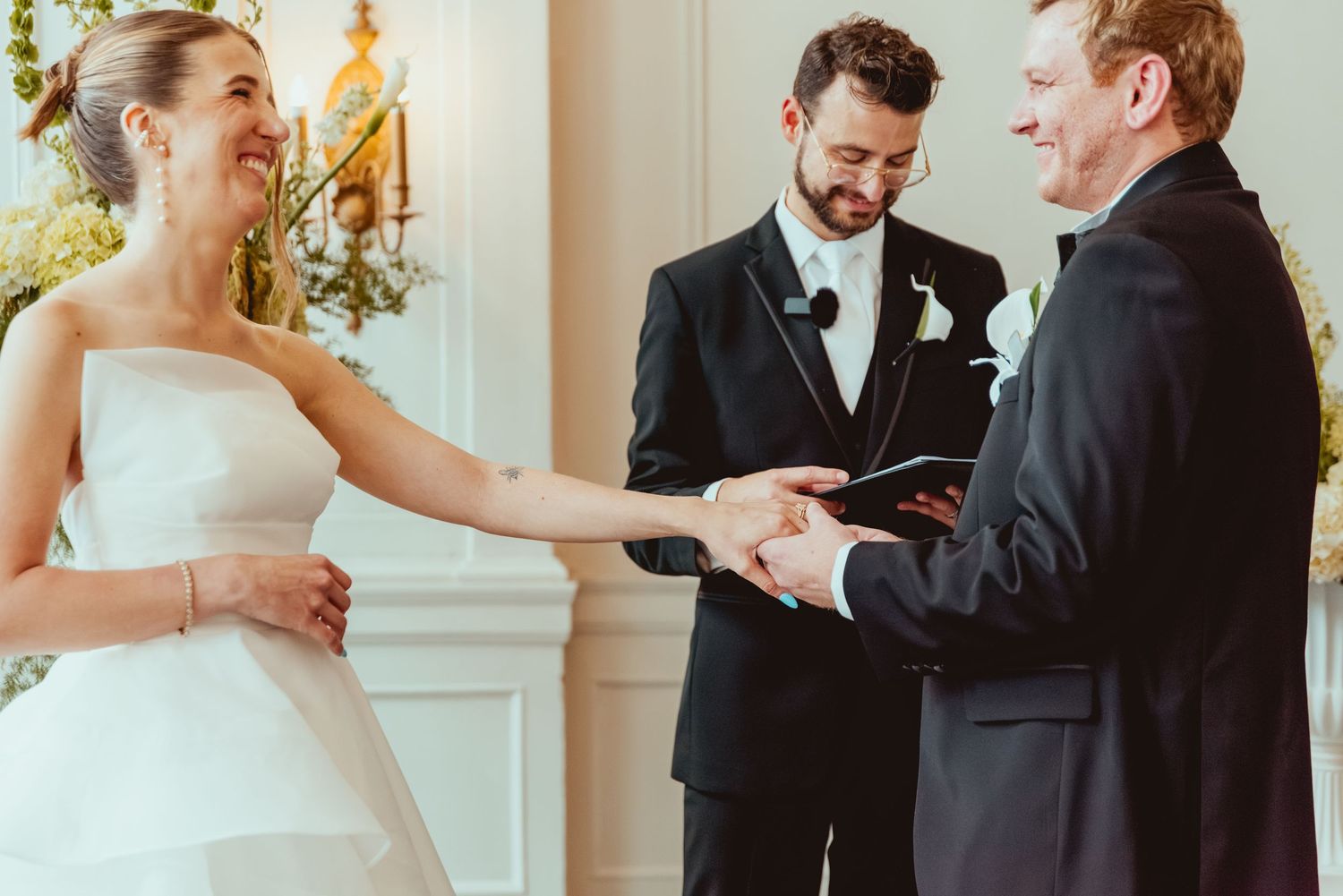 Wedding couple exchanges vows in an intimate ceremony with joyful expressions.