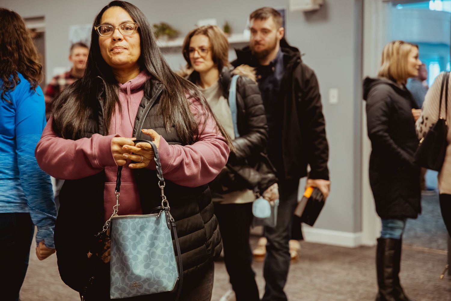 People gathering in a hallway at a social event or church meeting.