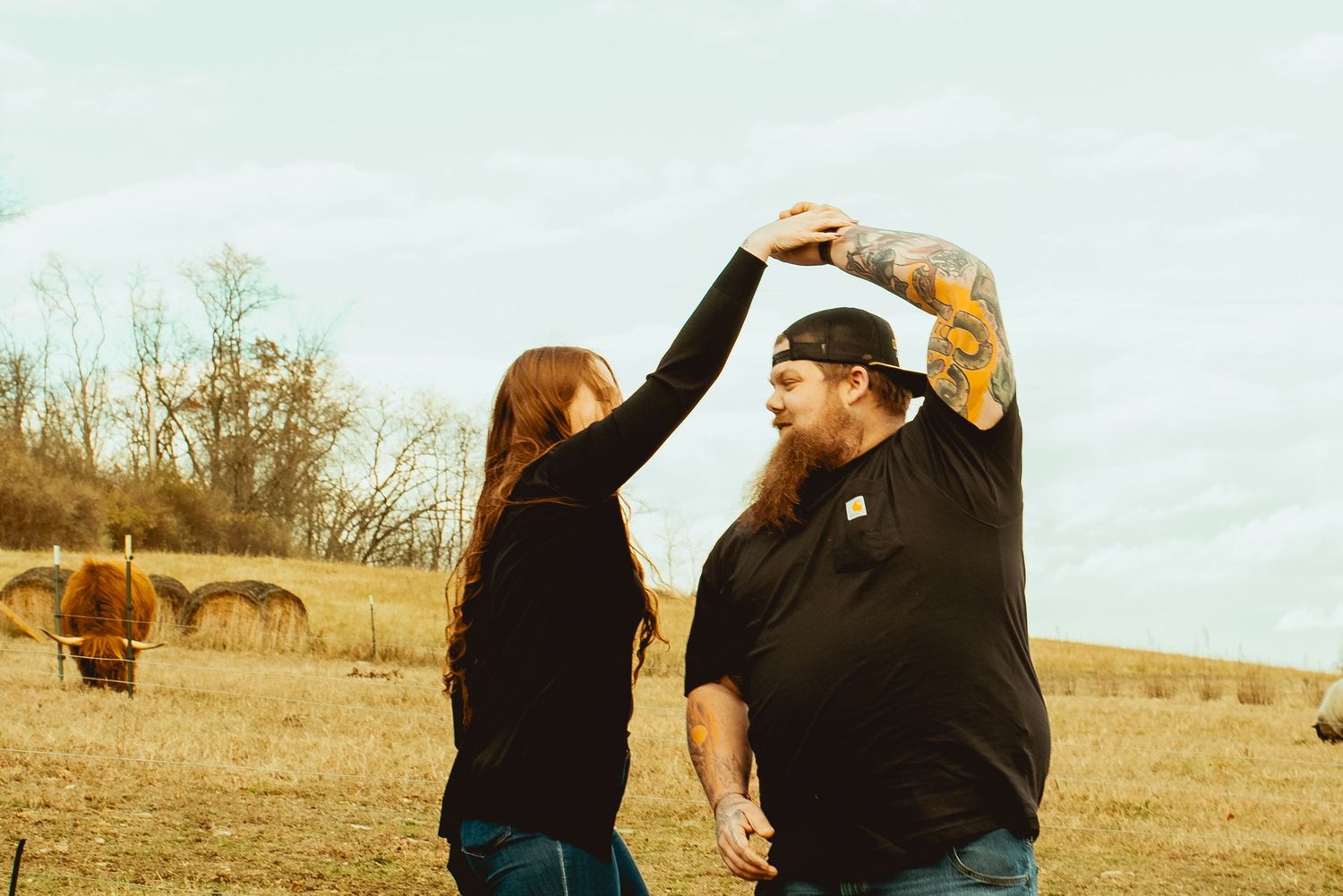 A sequence of photos showing a person in black clothing interacting with a horse in a rural field setting.
