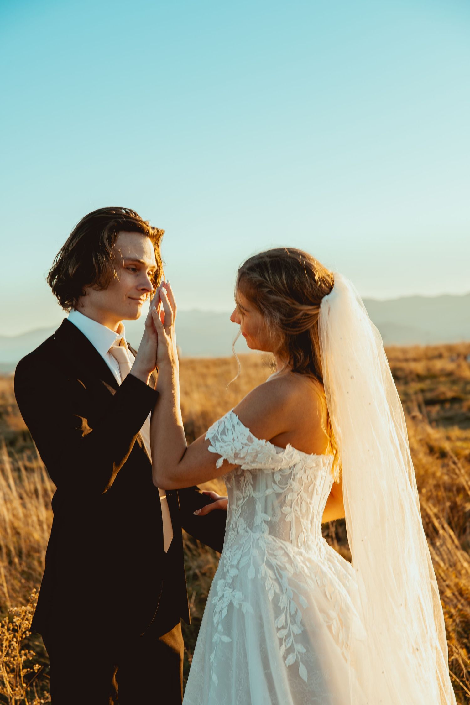 A romantic sunset wedding moment captured in a desert setting.