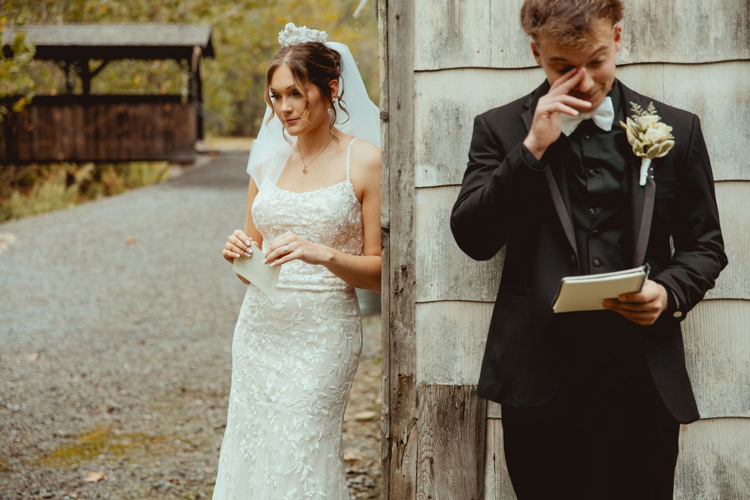 A couple shares a tender moment during their wedding celebration while standing outdoors in formal attire.