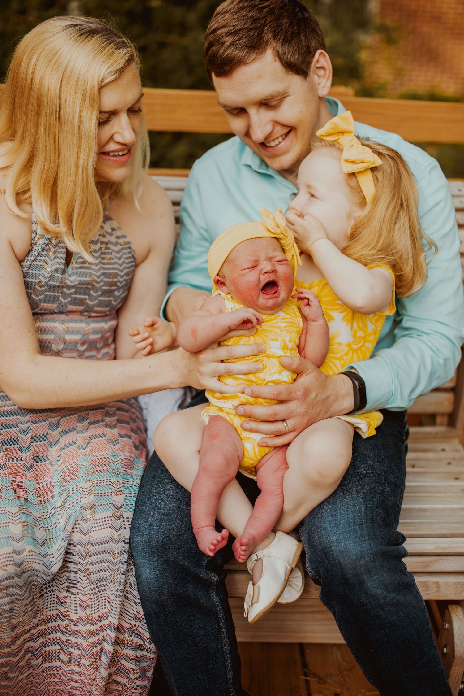 A family shares joyful moments together on a wooden bench in a series of candid photographs.