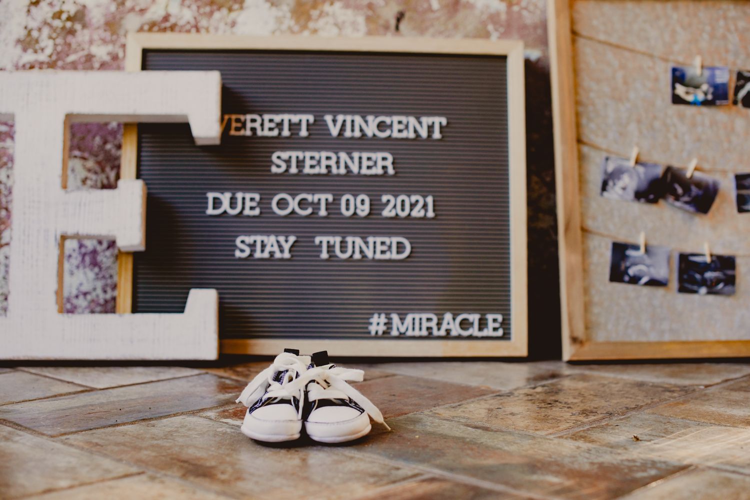 Wedding venue details display with frames and decorative elements on a rustic wooden surface.