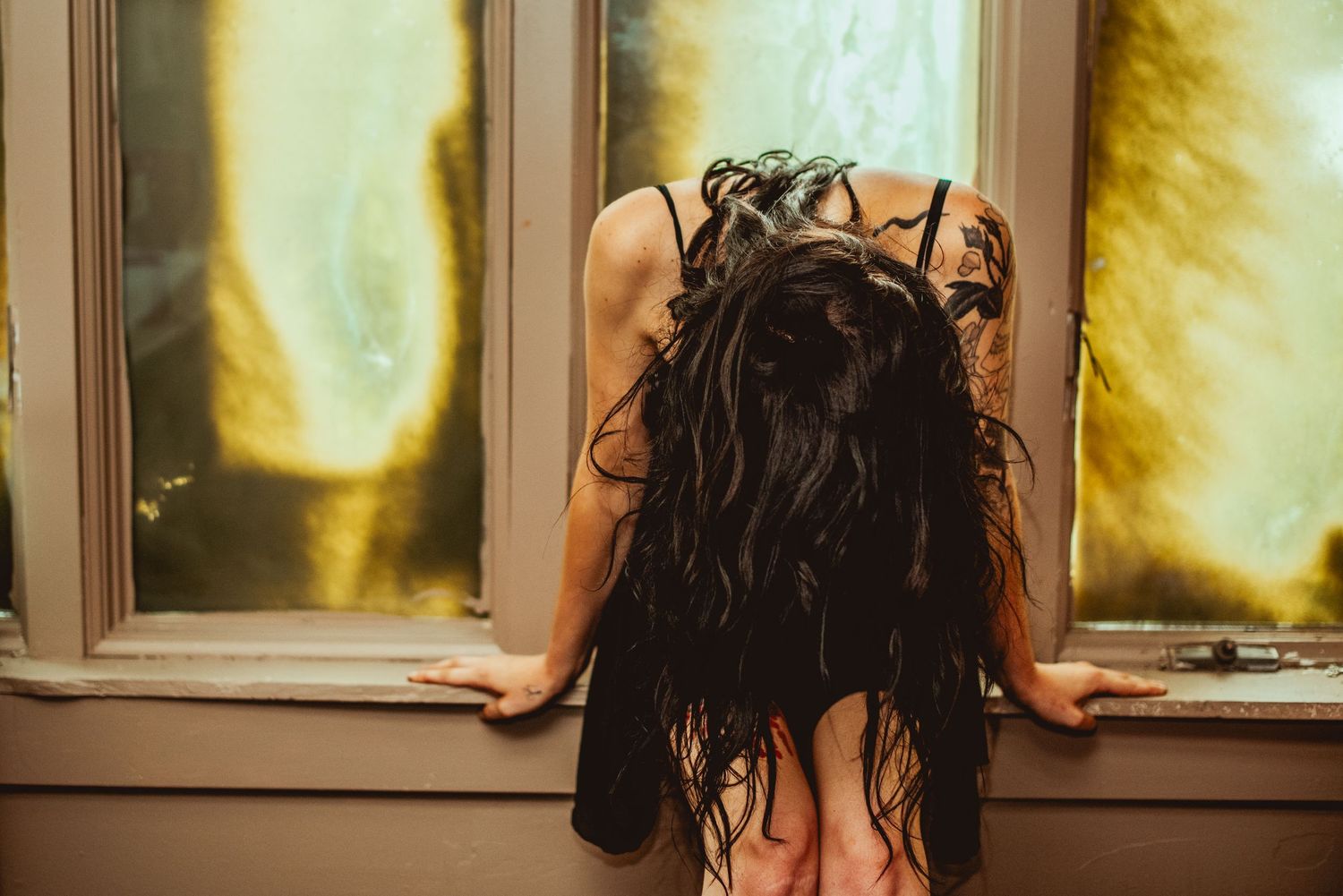 A series of six similar photos showing someone with wet hair looking out a window with dramatic lighting.