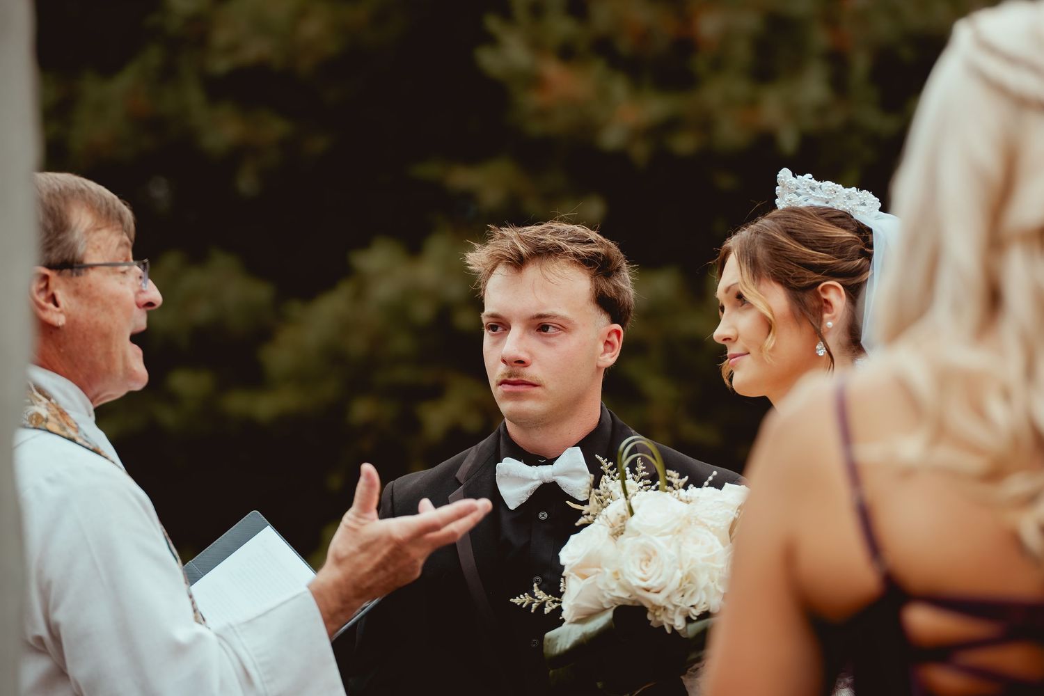 A wedding ceremony moment captured during an outdoor autumn celebration.
