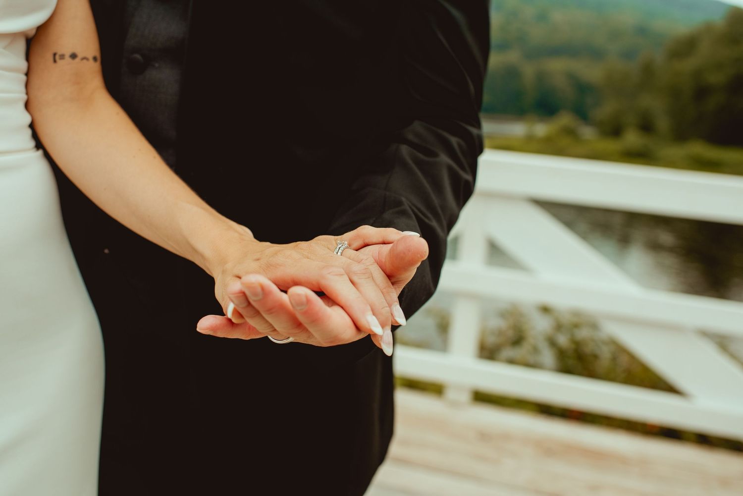 Couples dancing together on an outdoor white deck during a celebration.
