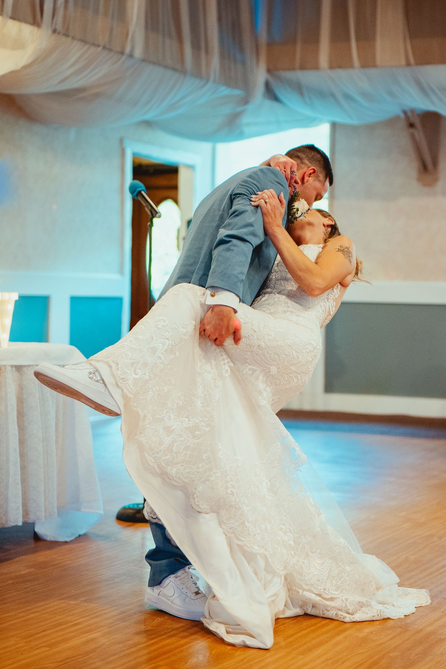 Romantic first dance sequence showing a dip move on a wooden dance floor.