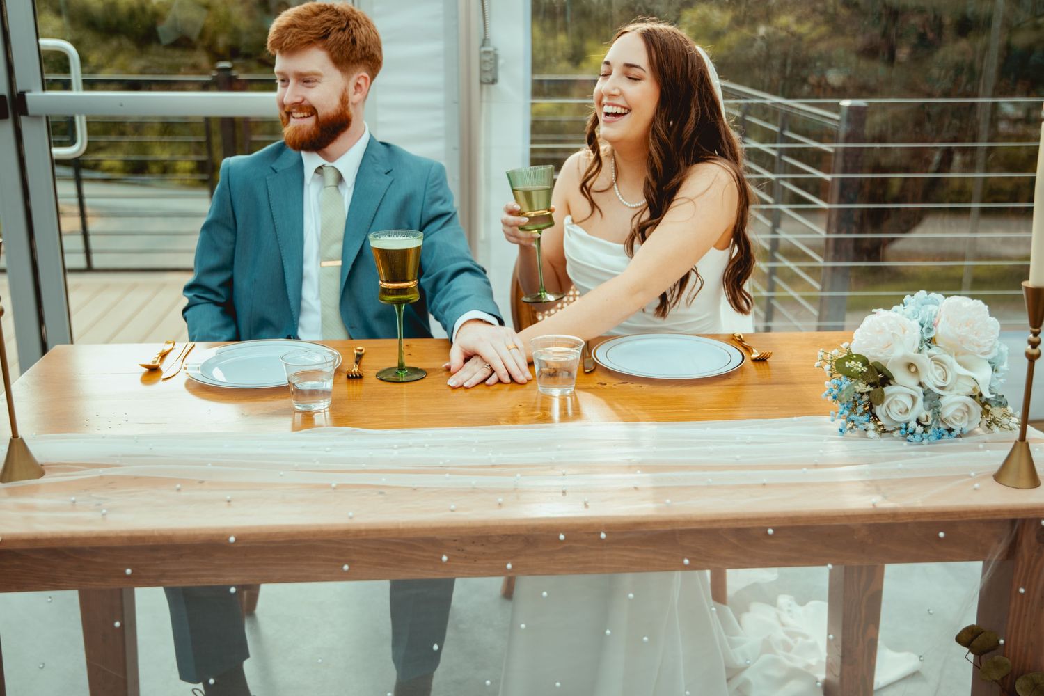 Candid wedding reception moments captured at outdoor venue with glass architecture.