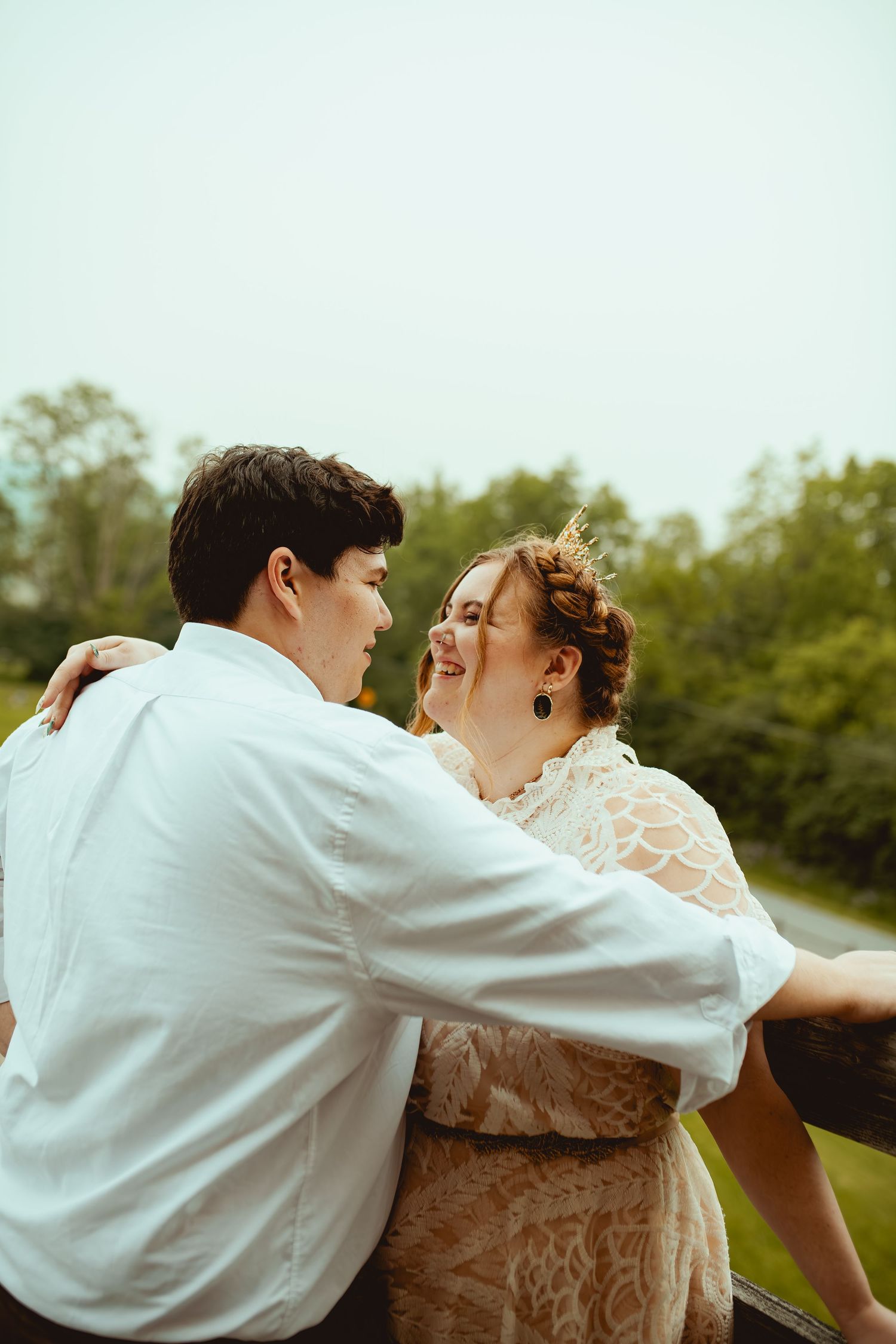 A couple in wedding attire share a romantic dance outdoors in a sequence of four candid shots.