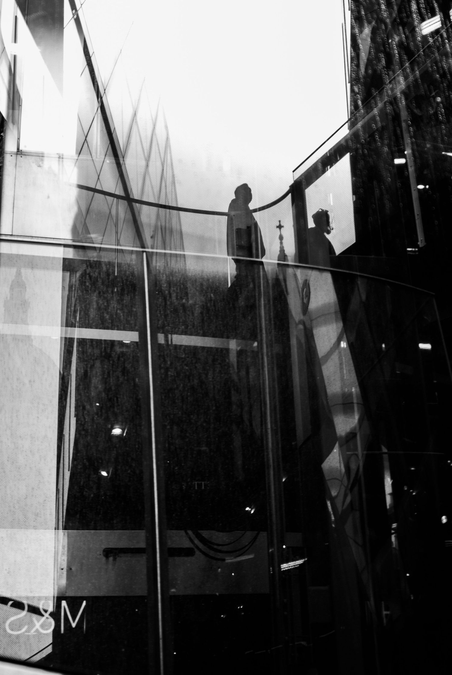 Minimalist black and white architectural interior with dramatic lighting and reflections.