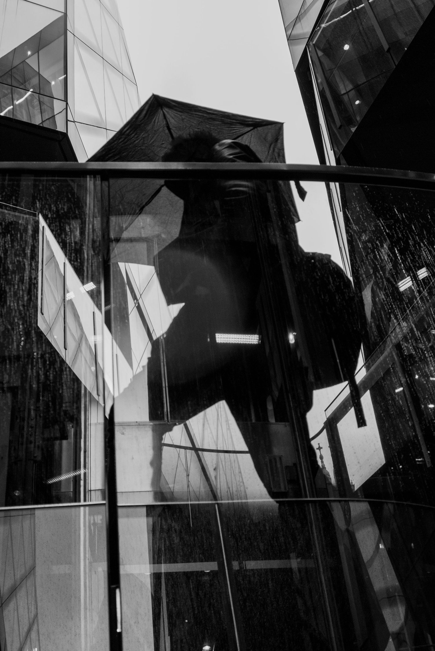 Abstract monochrome pattern of architectural shadows and geometric lines on an angular wall surface.