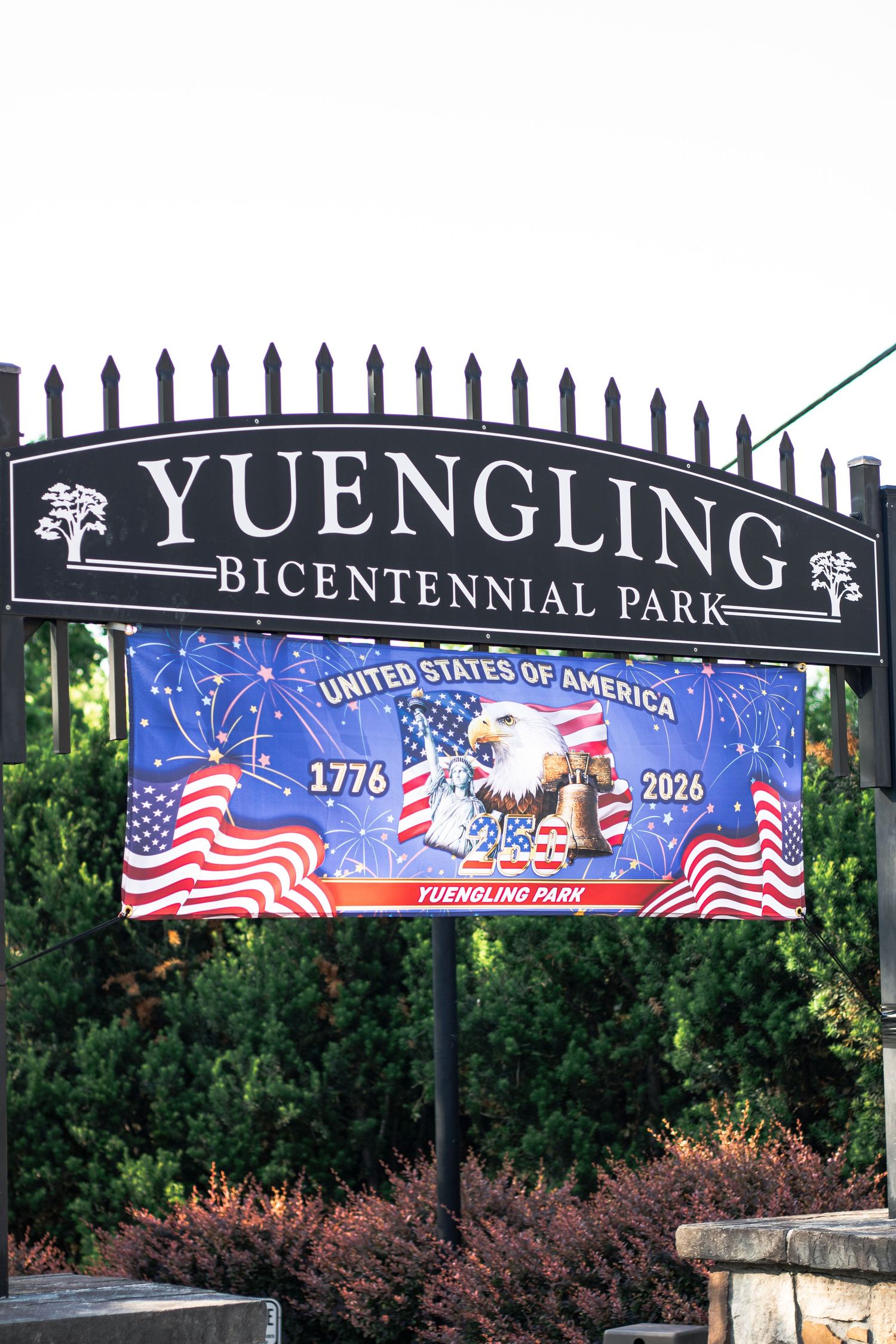 Yuengling Bicentennial Park sign with a patriotic banner celebrating the USA 1776-2026 anniversary featuring a bald eagle.